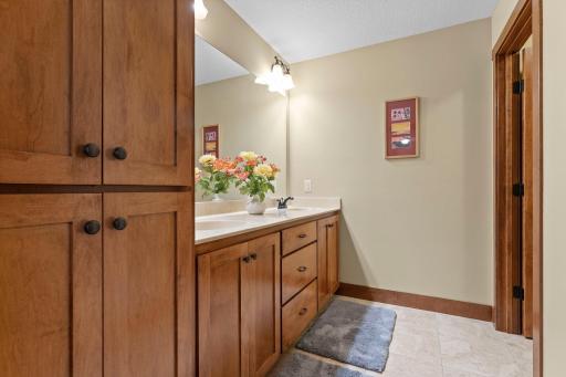 The upper level full bath features double sinks and lots of cabinet space.