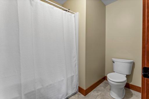The upper level bathroom includes the option to close off the tub and toilet from the sink area.