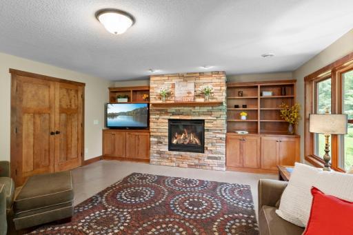The lower level family room includes a gas fireplace and gorgeous wooden built-ins.