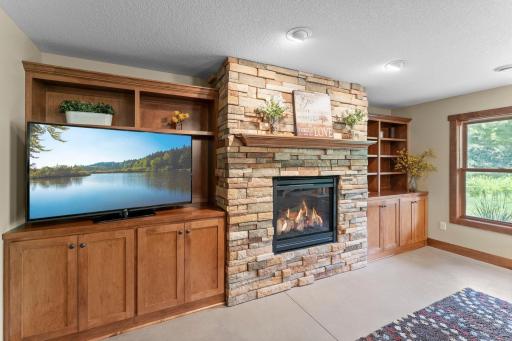The lower level family room includes a gas fireplace and gorgeous wooden built-ins.