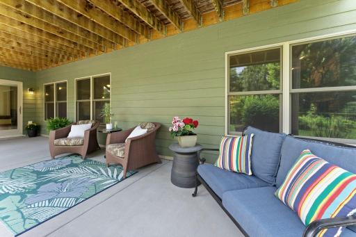 The back patio is covered by the deck, offering a shady place to enjoy time outside.