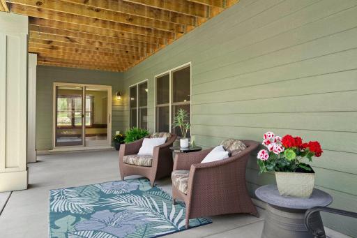 The back patio is covered by the deck, offering a shady place to enjoy time outside.