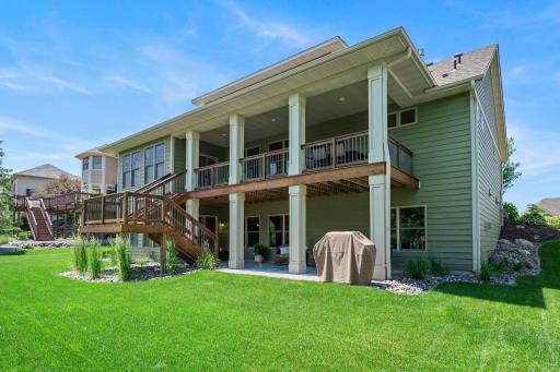 This home features a gorgeous deck and a meticulously cared for lawn.