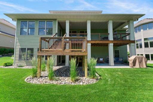 This home features a gorgeous deck and a meticulously cared for lawn.