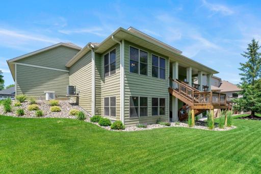 This home features a gorgeous deck and a meticulously cared for lawn.