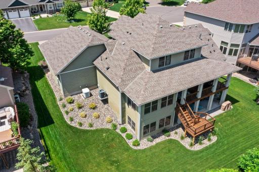 This home features a gorgeous deck and a meticulously cared for lawn.