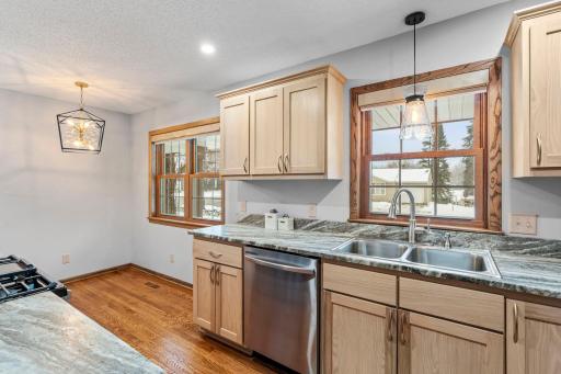 Kitchen windows brings in a ton of natural light. Upgraded custom blinds in kitchen and living room.