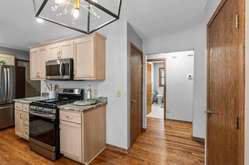 Gorgeous hardwood flooring spans the entire main level - living room, kitchen, hallway, and bedrooms.