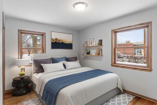 Primary bedroom. 3 bedrooms on the main level. Abundance of windows bring in a ton of natural light. Neutral paint and gorgeous hardwood flooring. (virtually staged for inspiration)