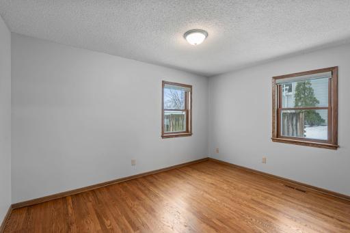 Primary bedroom. 3 bedrooms ont he main level. Abundance of windows bring in a ton of natural light. Neutral paint and gorgeous hardwood flooring.