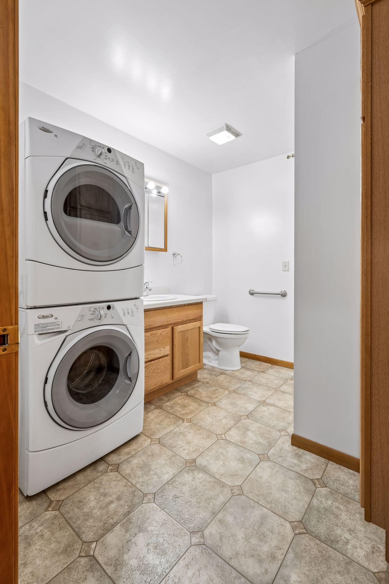 Additional main floor bath featuring washer and dryer