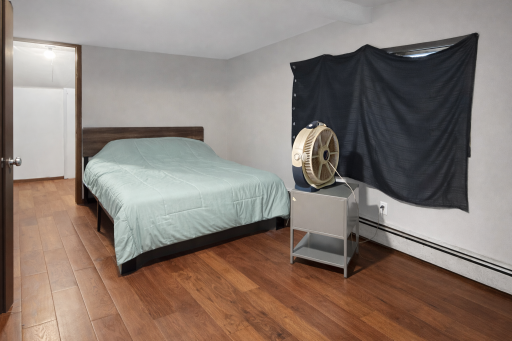 Upper Level Bedroom 1 with plank floors and walk-in closet.