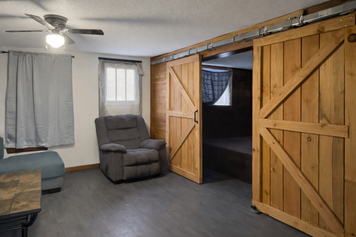 Barn doors in living room lead to main floor bedroom