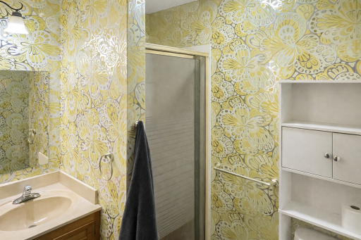 Main floor 3/4 bath with unique wallpaper