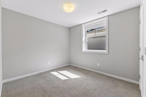 The forth bedroom with a private bathroom across the hall and entry from the garage