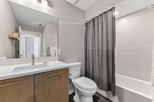 The forth, lower level bathroom with a tub and shower