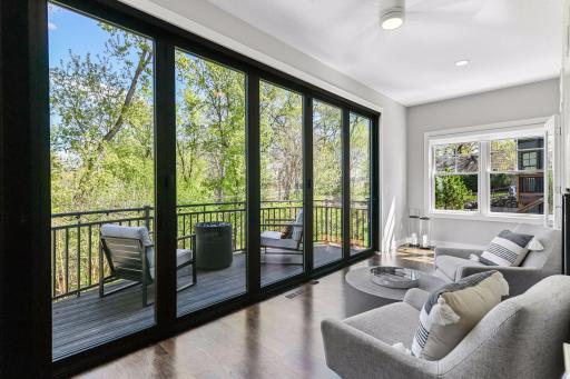 The four season or screened porch with 15 feet of glass that fully opens to let the outside in or can be used with a folding screen enclosure