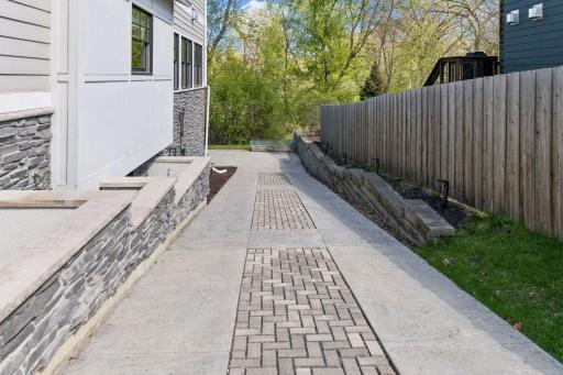 Another view of the finished concrete driveway with pavers and exterior stone