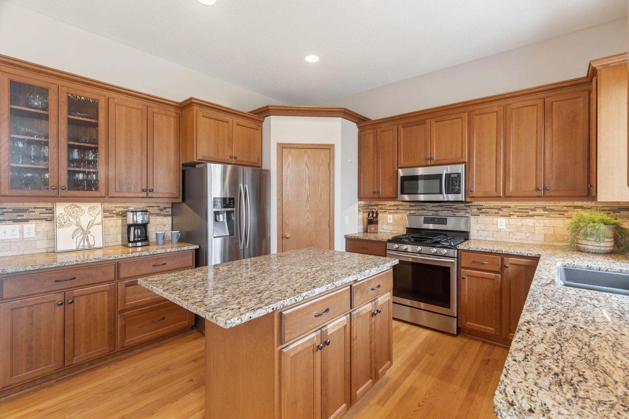 Refreshed kitchen with granite, stainless appliances & center island