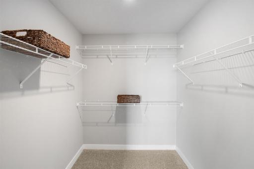 Huge walk-in closet in primary bedroom. Photo of actual home. Colors and options may vary. Ask Sales Agent for details.