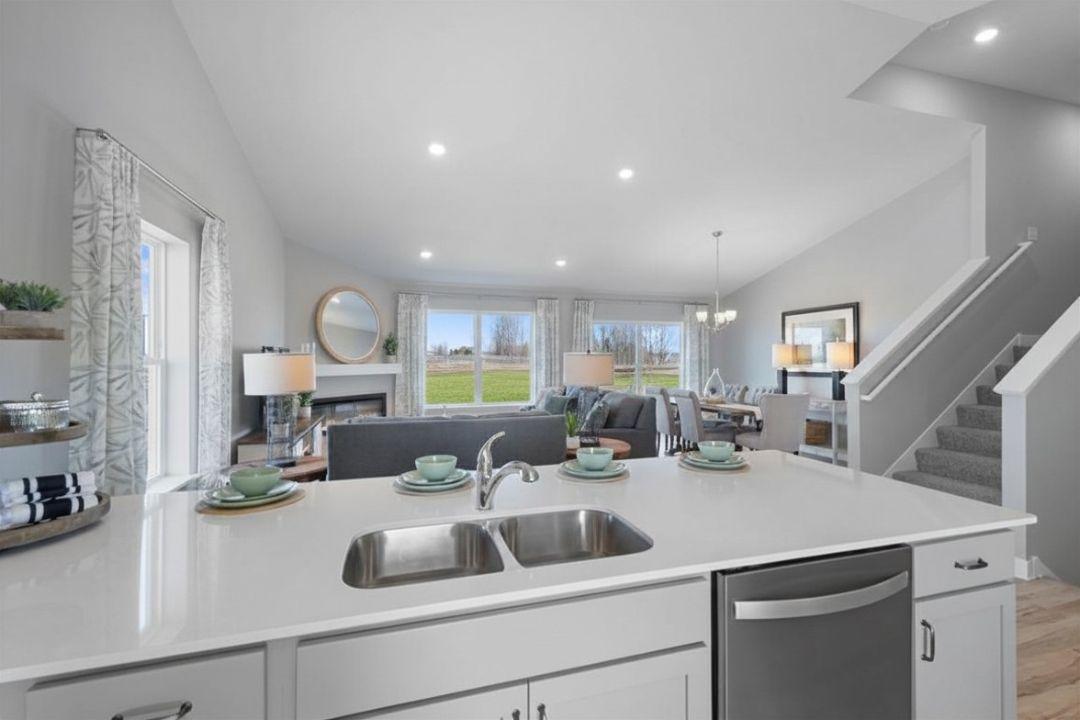 This massive cathedral vault hovers over the entire main level, equating in an openness rarely matched in new home design. Photo is of model home. Colors and options may vary. Ask Sales Agent for details.
