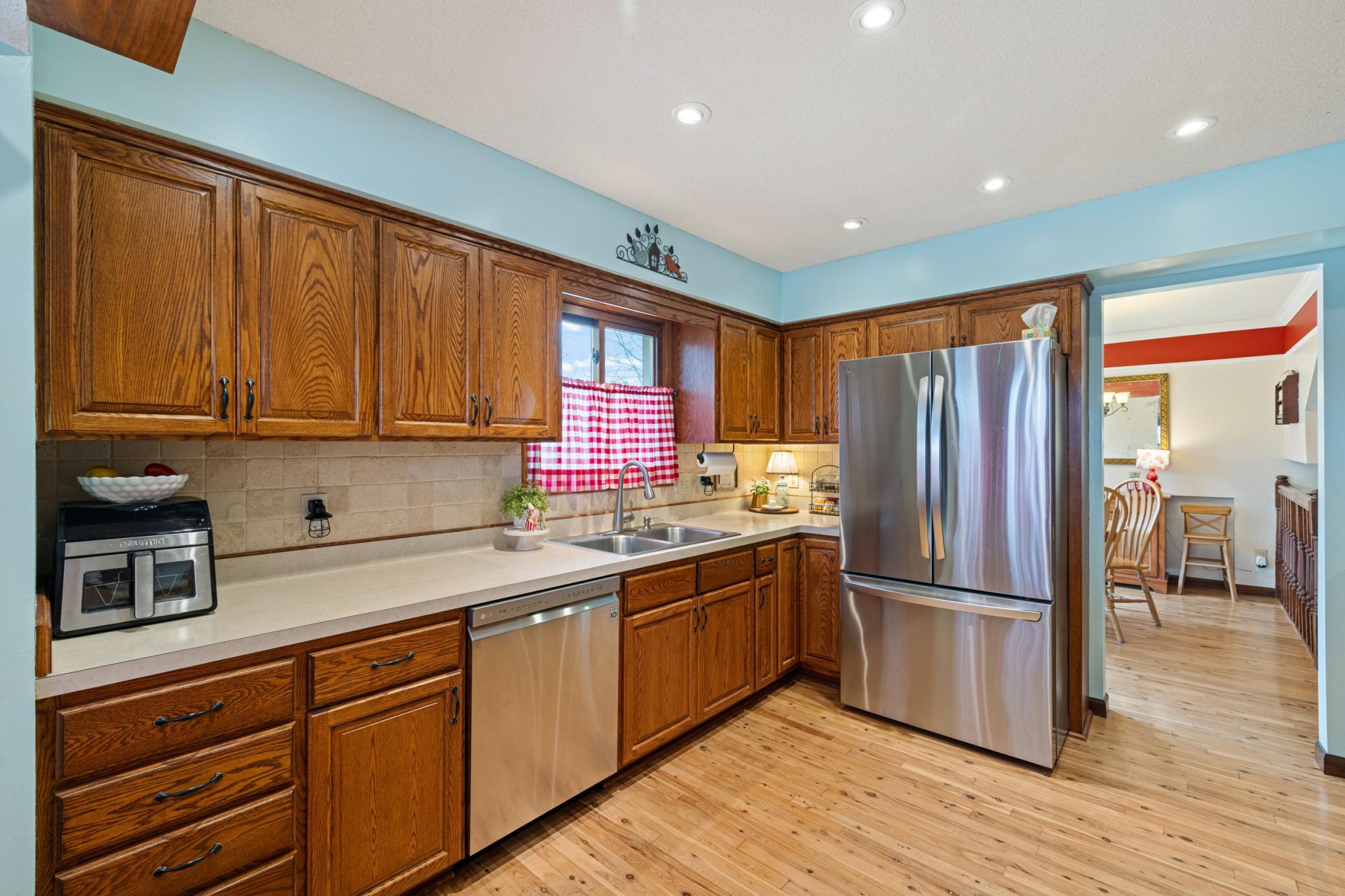 Kitchen offering hardwoods and Stainless steel appliances