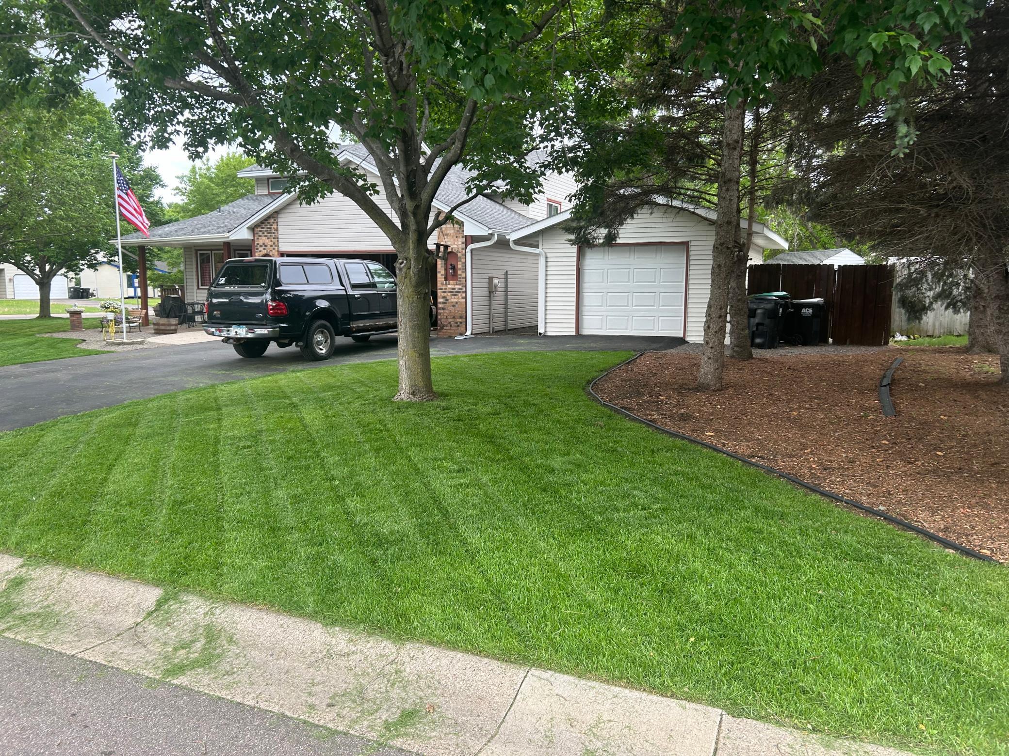 Front of home showing the lush green grass of last summer