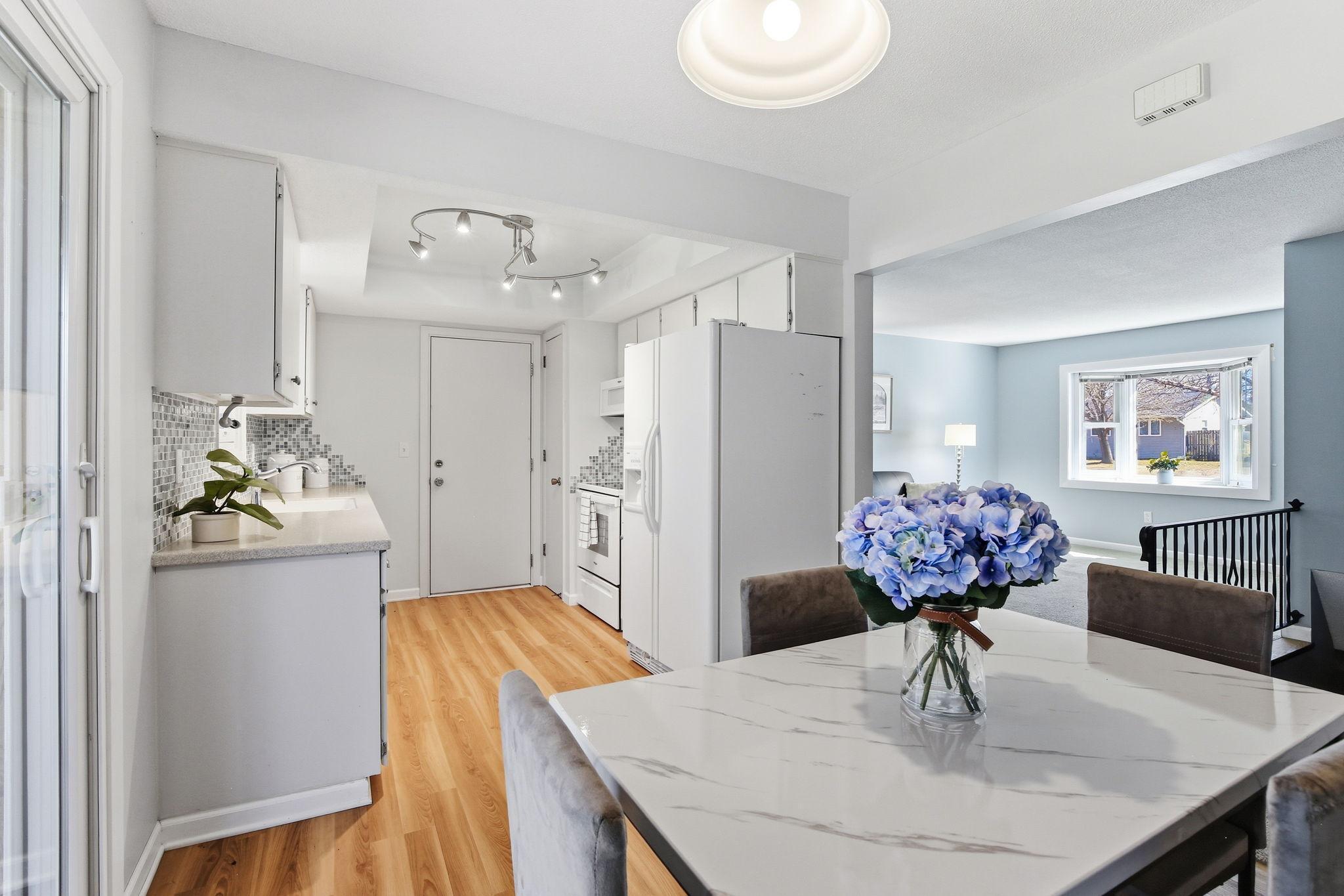 Kitchen Updated with Solid Surface Countertops, Tile Backsplash & Wood Floors.