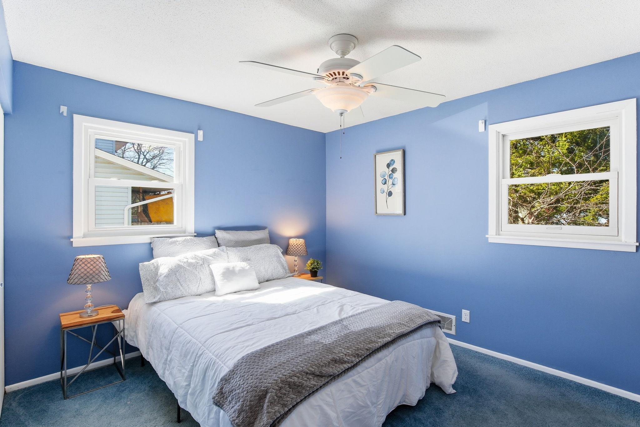 Main Bedroom with White Trim, Ceiling Fan and Large Closet. Hardwood floors under carpet.