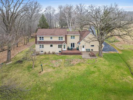 Surrounded by mature trees and 10-acres of open land, offering a sense of space and seclusion