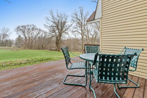 Deck overlooks the open yard and peaceful natural backdrop