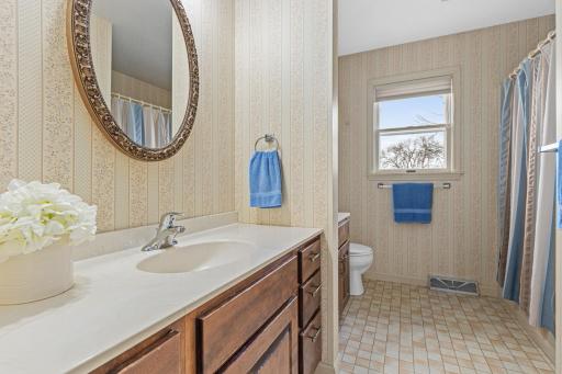 Upper-level Jack & Jill bath with dual vanity and functional layout for busy mornings