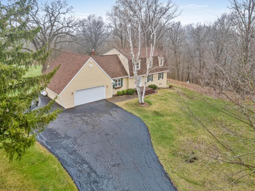 The approach unfolds with a long drive leading to a welcoming first impression