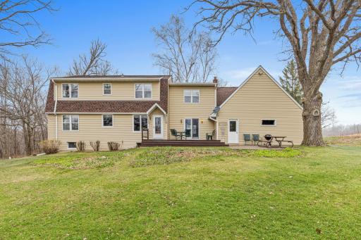 The backyard view highlights the homeâs inviting outdoor living spaces, set against a peaceful and private backdrop.
