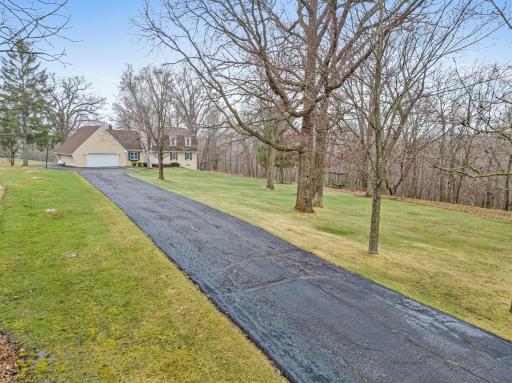 A long private driveway creates a quiet, tucked-away arrival