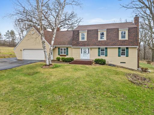 Mature trees and open lawn frame this inviting retreat