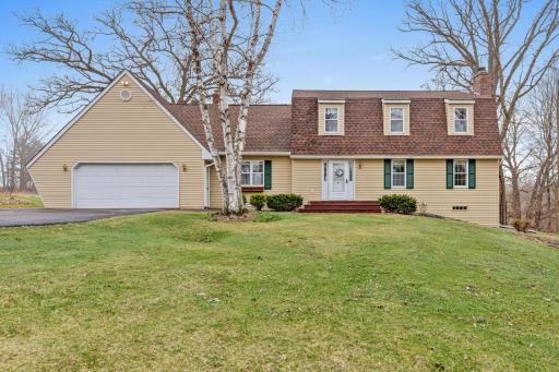 Classic country curb appeal welcomes you home to this peaceful 10-acre setting