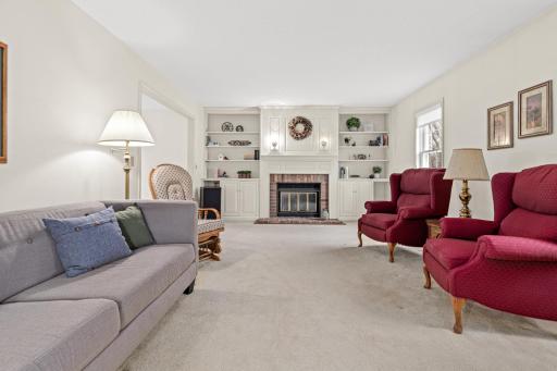 Light & bright living room centered around the fireplace and custom built-ins