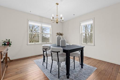 Formal dining room filled with natural light and views of the surrounding landscape