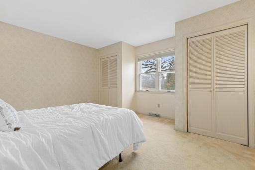 Generous 2nd upper-level bedroom with large windows and ample closet space
