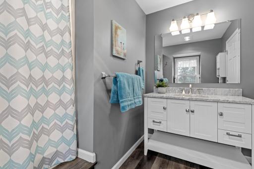Gorgeous 3/4 bath with updated finishes serves the primary suite