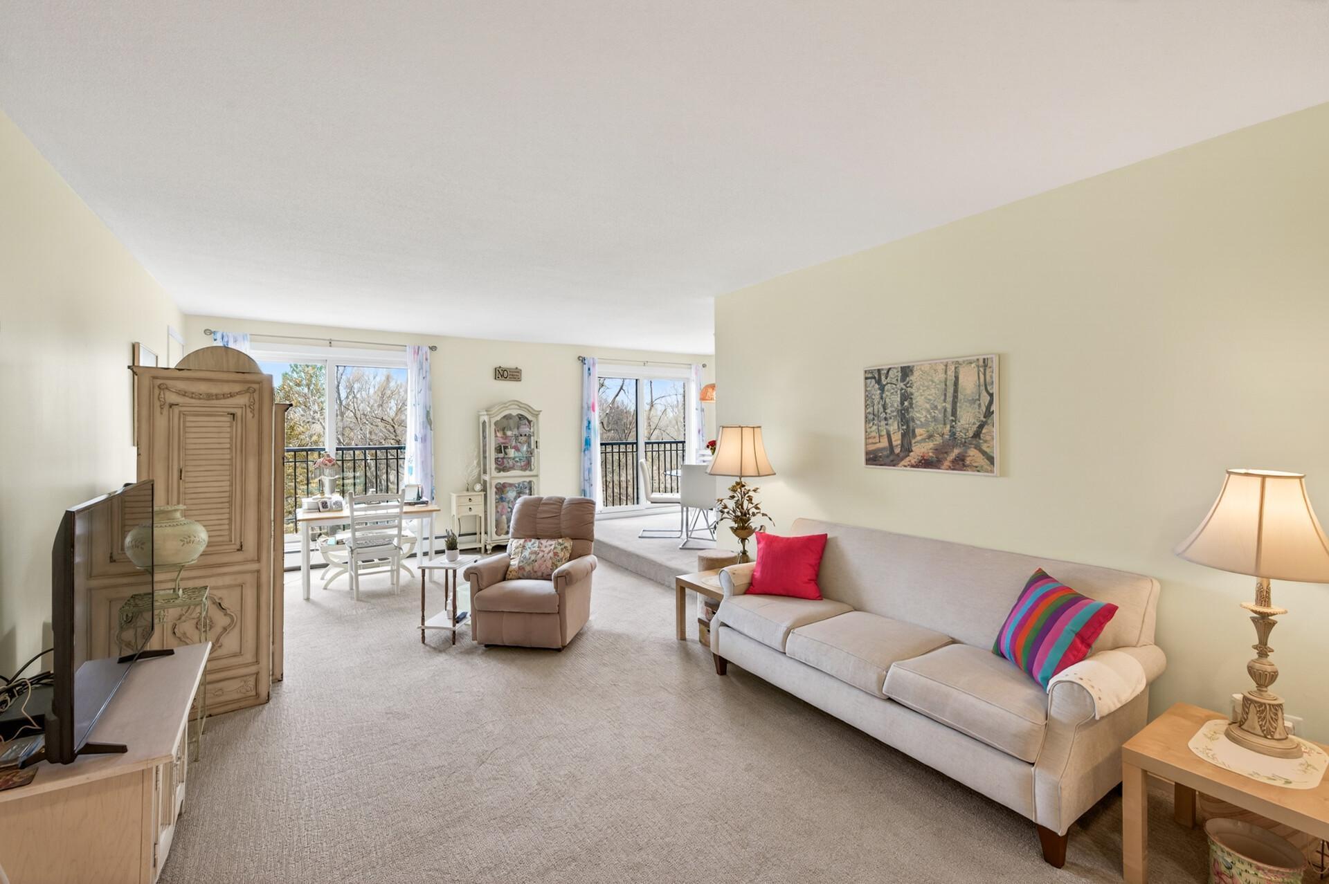 Large living room with 2 sliding doors that let it in an abundance of natural light