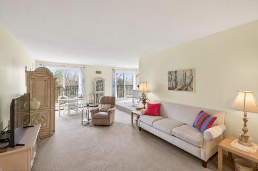 Large living room with 2 sliding doors that let it in an abundance of natural light