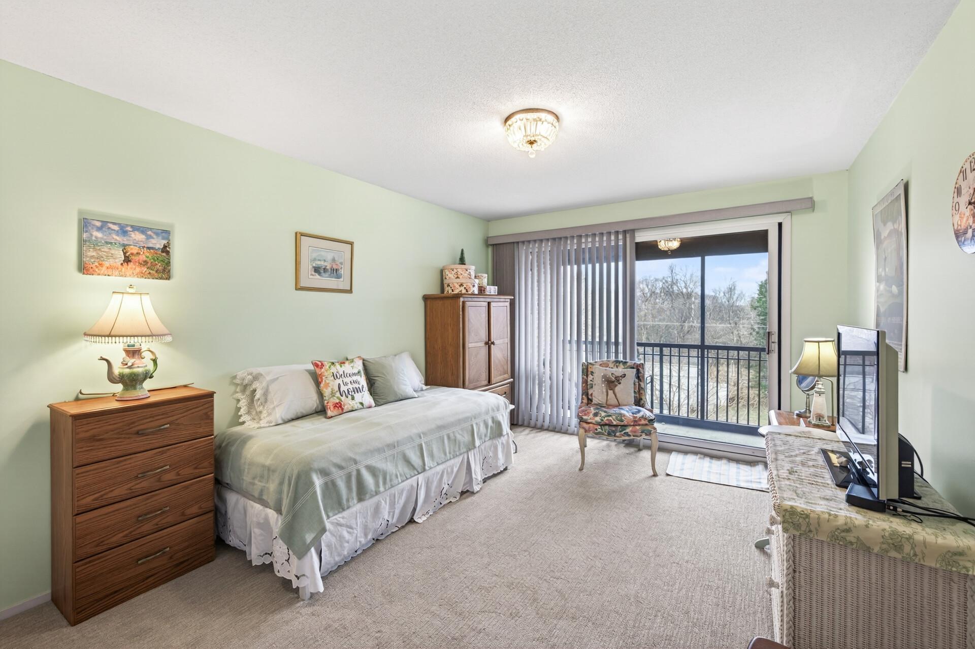 Large bedroom with sliding door to screen porch