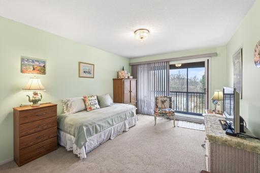 Large bedroom with sliding door to screen porch