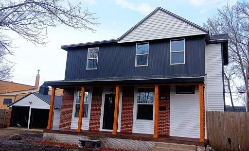 Front of house with brand new siding and updated porch with new windows and door