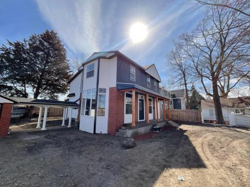Side view of home featuring the brand new bay window from your spacious vaulted Living Room