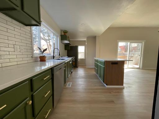 Brand new kitchen with center Island and brand new flooring and stainless steel appliances