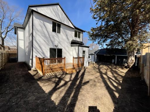 Side view of back of home featuring brand new siding and brand new roof throughout the house