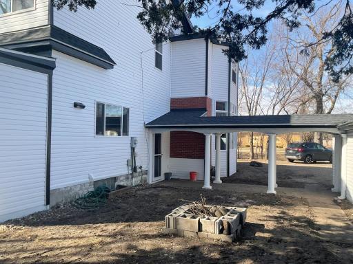 More picsshowing open breezeway ( sod will be added ). Brand new siding and roof